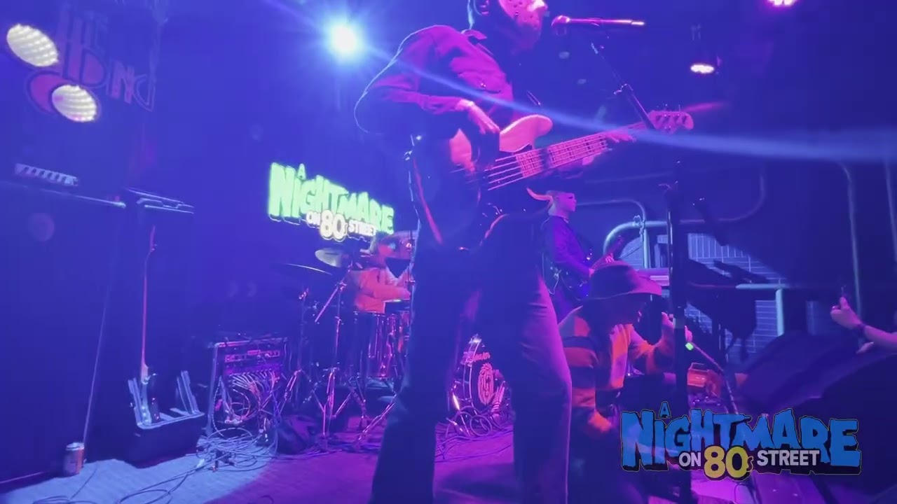 A Nightmare on 80s Street performing Let’s Dance under purple stage lights